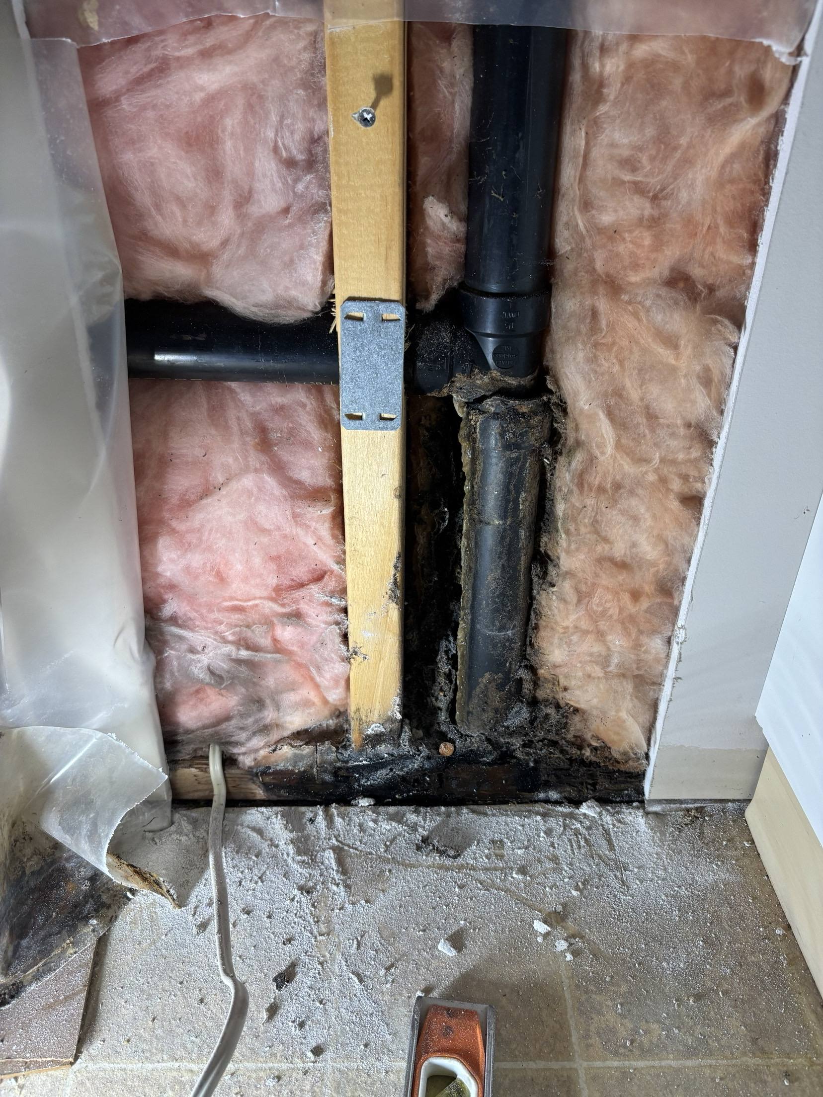 Corroded in-wall drain stack before replacement