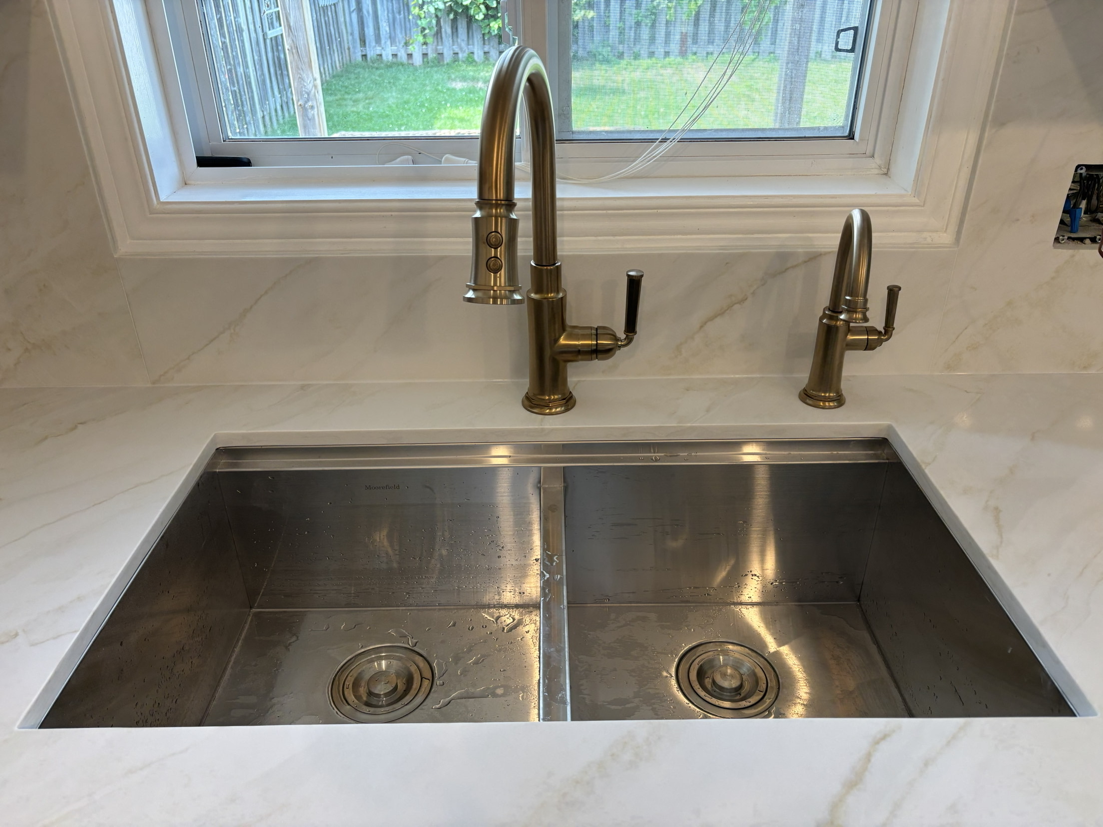 Finished kitchen sink and faucet installation by ARD Plumbing